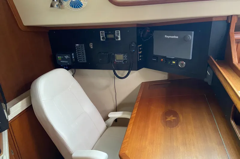Priva Sea Yacht Photos Pics Navigation station of 2003 Island Packet 485 yacht with control panel and white chair.