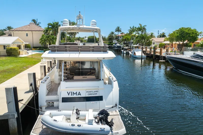  Yacht Photos Pics Luxury 2018 Prestige 680 yacht docked in a scenic canal setting.
