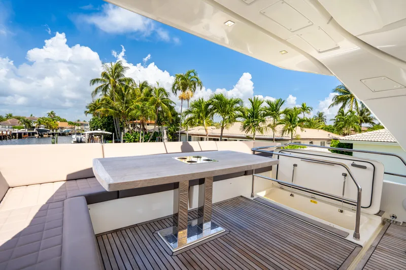  Yacht Photos Pics Luxury outdoor seating on 2018 Prestige 680 yacht, with tropical palm tree backdrop.