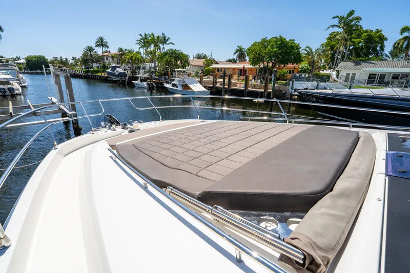  Yacht Photos Pics Luxurious 2018 Prestige 680 yacht with sun pad, docked in a scenic marina.