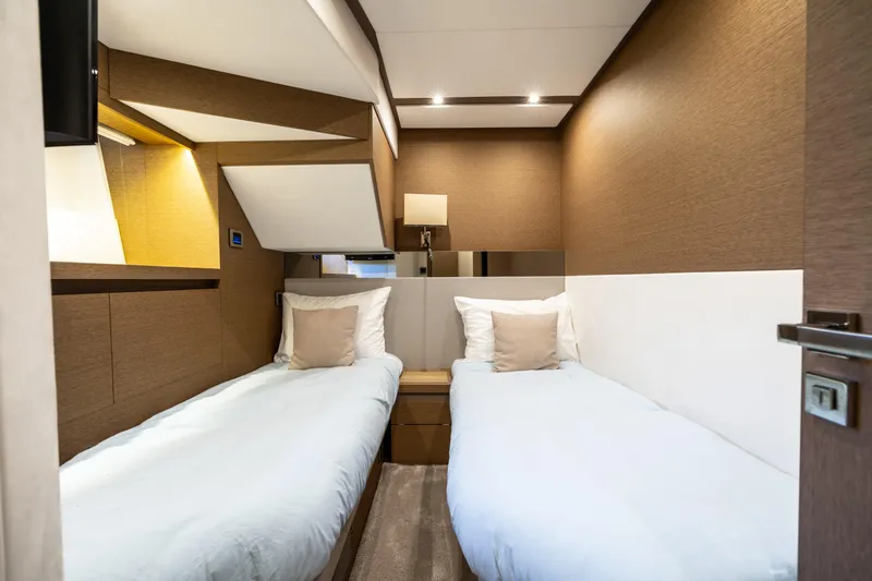  Yacht Photos Pics Luxurious twin cabin interior on 2018 Prestige 680 yacht, featuring modern design and cozy bedding.