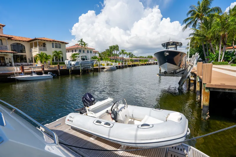  Yacht Photos Pics Luxurious waterfront view with boats and a 2018 Prestige 680 yacht docked.