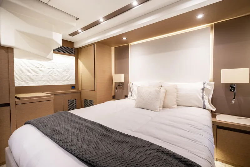  Yacht Photos Pics Luxurious bedroom interior of 2018 Prestige 680 yacht, featuring elegant bedding and modern lighting.