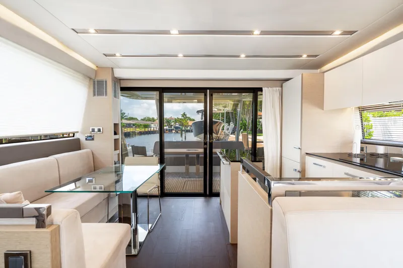  Yacht Photos Pics Luxurious interior of 2018 Prestige 680 yacht with modern furnishings and glass doors.