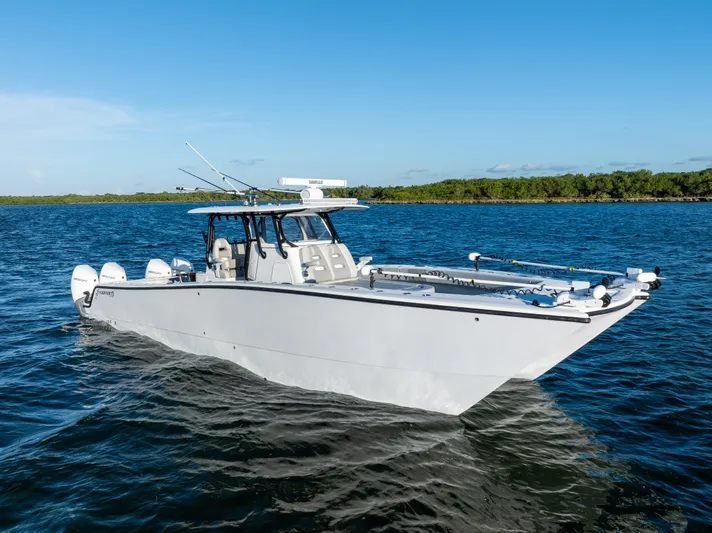  Yacht Photos Pics 2020 Freeman 37 VH boat on water, clear sky, lush shoreline in background.