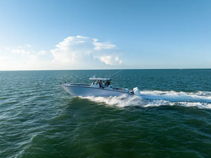  Yacht Photos Pics A Freeman 37 VH boat cruising on open water under a clear blue sky.