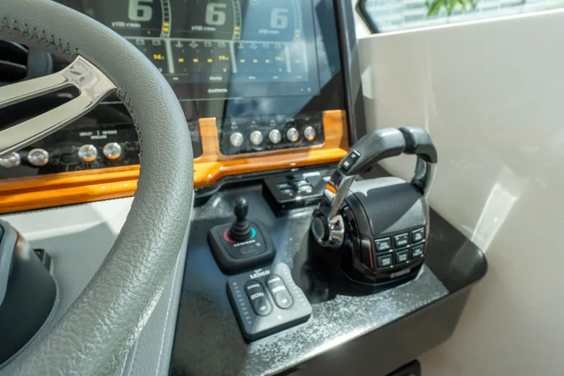  Yacht Photos Pics Control panel of 2021 Tiara Sport 38 LX boat with steering wheel and throttle.