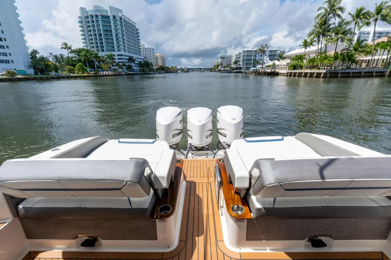  Yacht Photos Pics 2021 Tiara Sport 38 LX yacht with luxurious seating, docked in a scenic waterfront location.