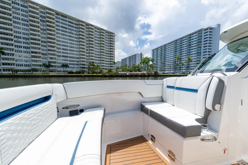  Yacht Photos Pics 2021 Tiara Sport 38 LX boat interior with modern seating, cityscape background.