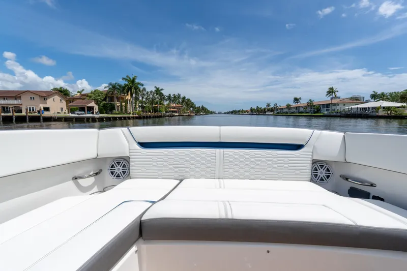  Yacht Photos Pics 2021 Tiara Sport 38 LX boat interior with waterfront view, palm trees, and blue sky.