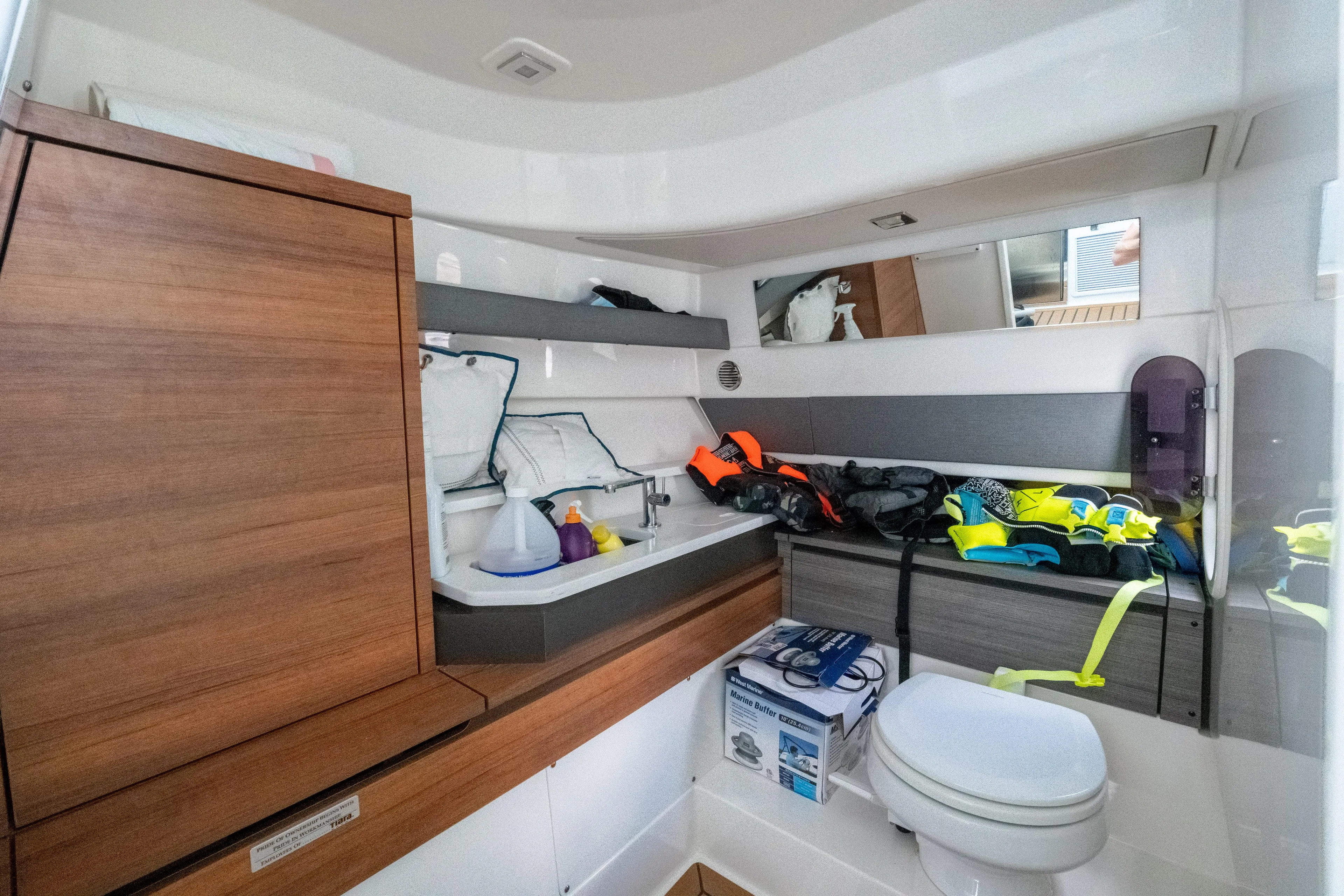  Yacht Photos Pics Interior of 2021 Tiara Sport 38 LX boat with life jackets and marine equipment.