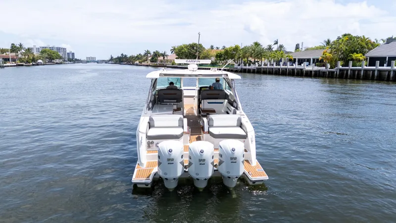  Yacht Photos Pics 2021 Tiara Sport 38 LX boat cruising on a scenic waterway.