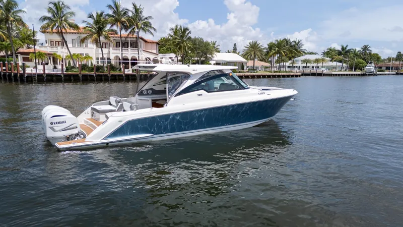  Yacht Photos Pics 2021 Tiara Sport 38 LX boat on a scenic waterway with palm trees.