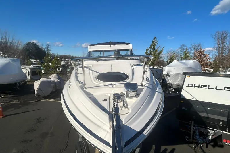  Yacht Photos Pics 2024 Regal 28 Express boat in outdoor storage, clear blue sky background.