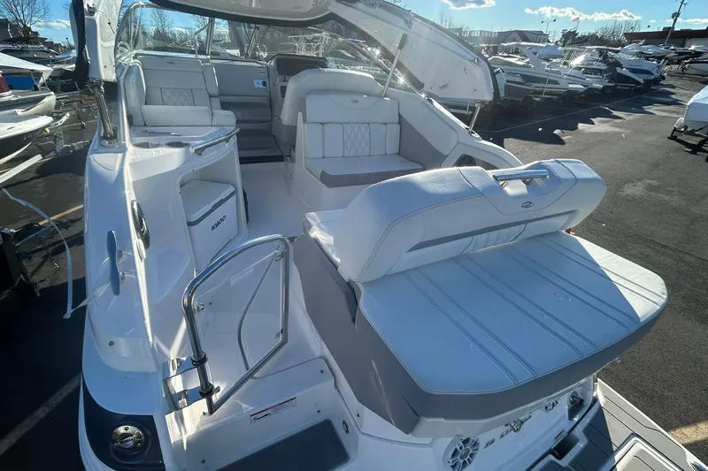  Yacht Photos Pics 2024 Regal 28 Express boat interior with white seating and modern design.