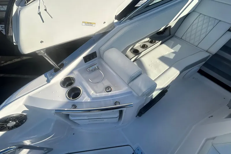  Yacht Photos Pics 2024 Regal 28 Express boat interior with seating and cup holders.