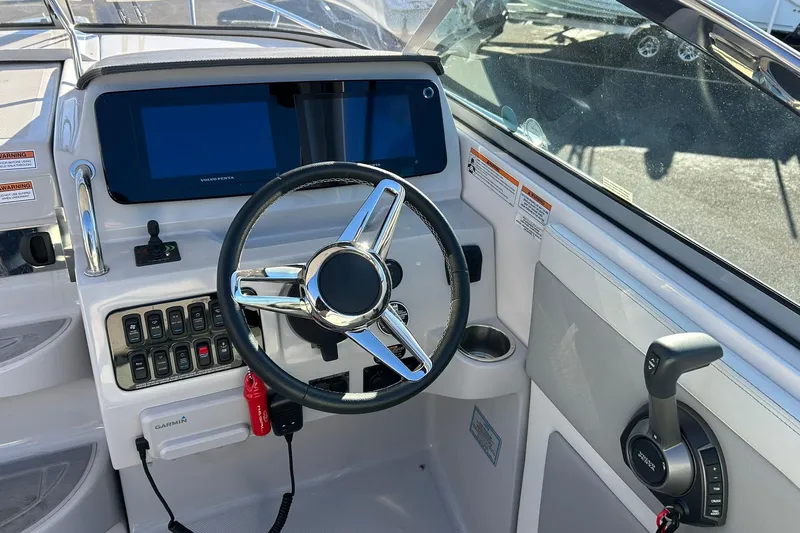  Yacht Photos Pics 2024 Regal 28 Express boat helm with steering wheel, controls, and navigation display.