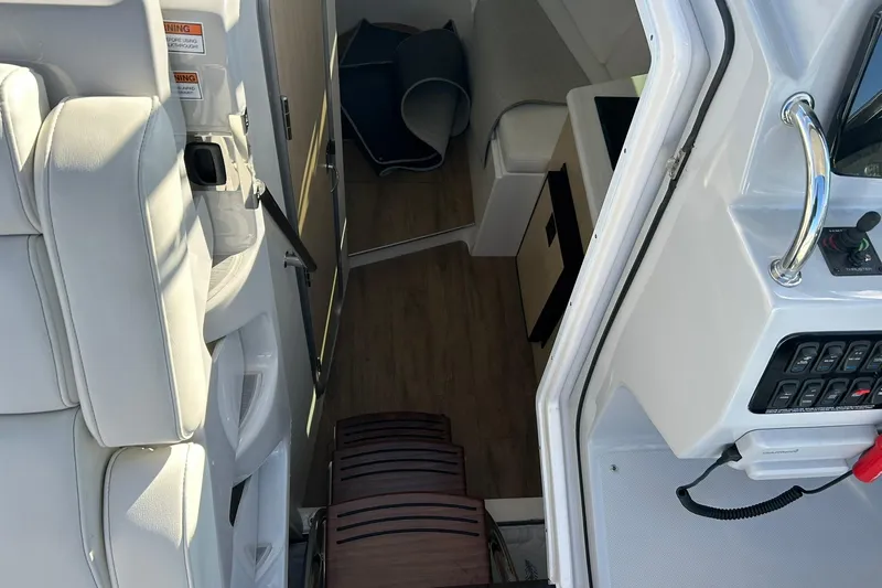 Yacht Photos Pics Interior view of 2024 Regal 28 Express boat, featuring seating and control panel.