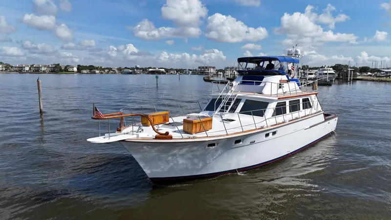 Liberty Belle Yacht Photos Pics 1980 Bertram 58 Convertible Custom yacht on calm water under a blue sky.