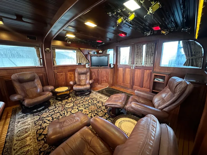 Liberty Belle Yacht Photos Pics Luxurious 1980 Bertram 58 Convertible Custom yacht interior with leather seating and elegant wood paneling.