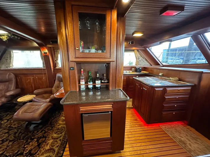 Liberty Belle Yacht Photos Pics Luxurious interior of a 2010 Bertram 58 Convertible yacht with elegant wood finishes.