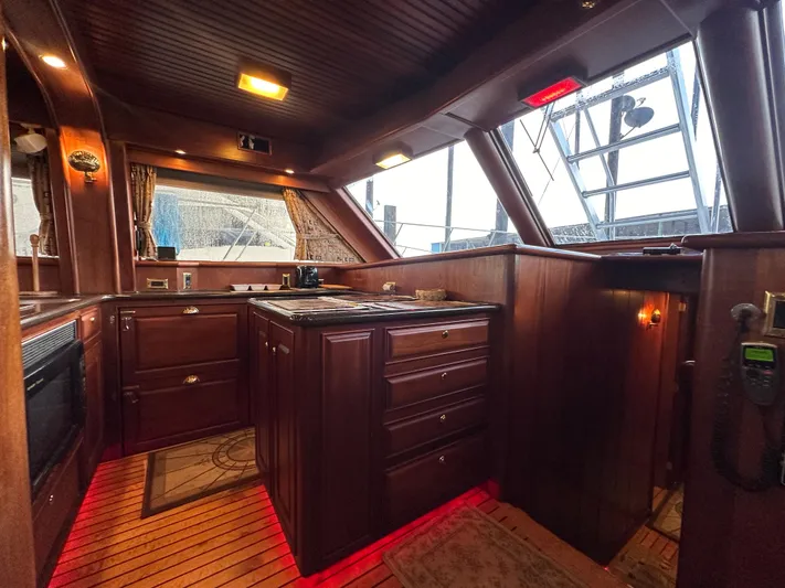 Liberty Belle Yacht Photos Pics Luxurious wooden interior of a 2010 Bertram 58 Convertible yacht kitchen.