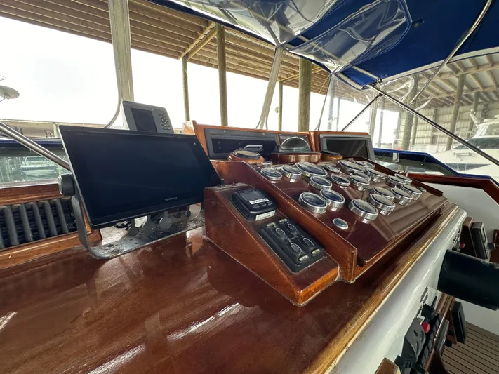 Liberty Belle Yacht Photos Pics Control panel of 1980 Bertram 58 Convertible Custom yacht with wooden dashboard and gauges.