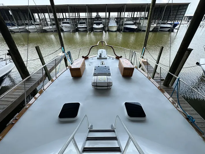 Liberty Belle Yacht Photos Pics 1980 Bertram 58 Convertible Custom yacht docked at marina, view from deck.