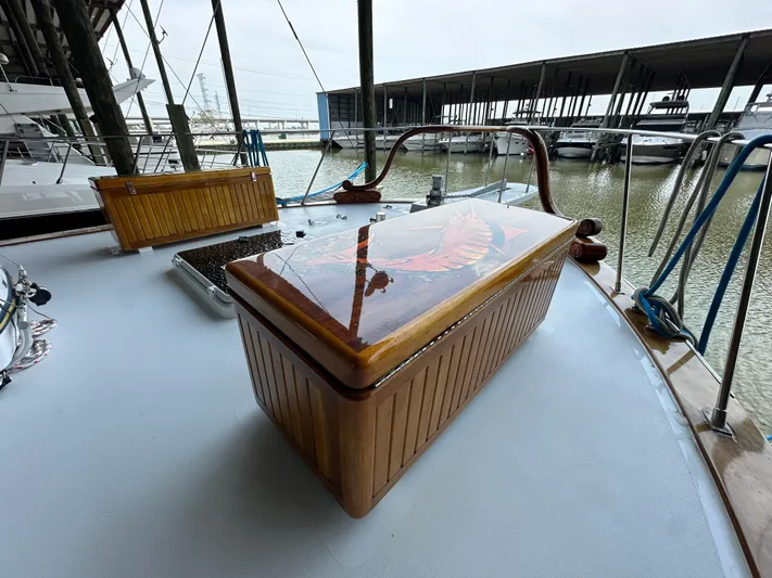 Liberty Belle Yacht Photos Pics 1980 Bertram 58 Convertible Custom yacht deck with wooden storage box.