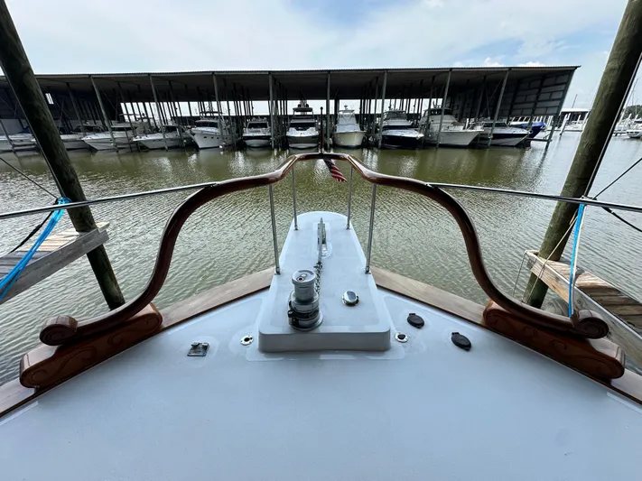 Liberty Belle Yacht Photos Pics 1980 Bertram 58 Convertible Custom yacht docked at marina, view from bow.