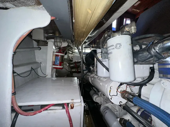 Liberty Belle Yacht Photos Pics Engine room of 1980 Bertram 58 Convertible Custom with visible filters and wiring.