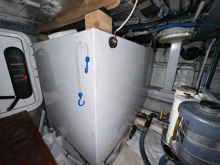 Liberty Belle Yacht Photos Pics Engine room of 1980 Bertram 58 Convertible Custom with storage tank and equipment.