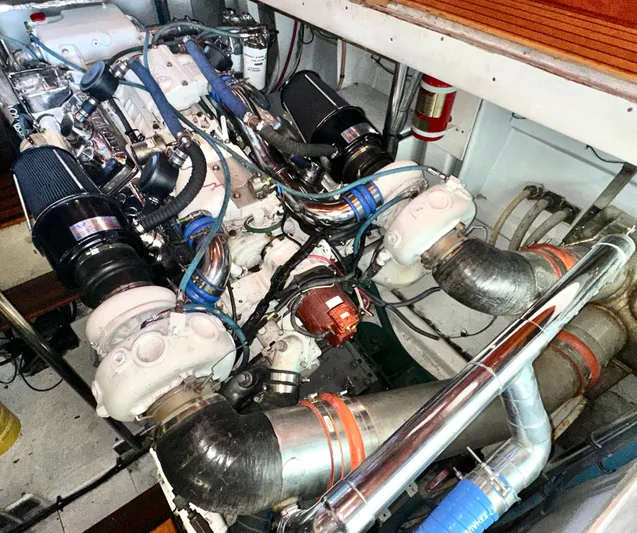 Liberty Belle Yacht Photos Pics Engine room of 1980 Bertram 58 Convertible Custom yacht, showcasing complex machinery and components.