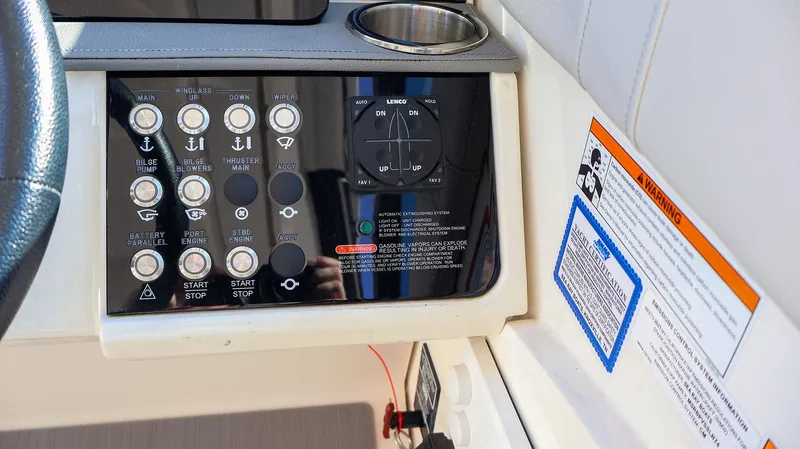 4743jg Yacht Photos Pics Control panel of 2021 Sea Ray 320 Sundancer boat with warning labels and cup holder.