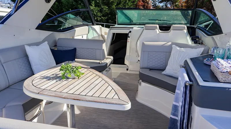 4743jg Yacht Photos Pics Luxurious 2021 Sea Ray 320 Sundancer interior with elegant seating and wooden table.