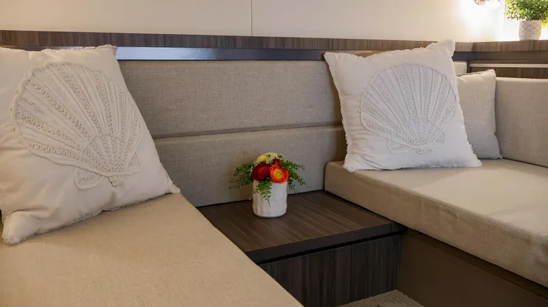 4743jg Yacht Photos Pics Interior of 2021 Sea Ray 320 Sundancer with beige seating and decorative pillows.