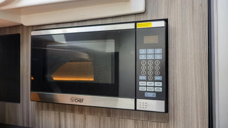 4743jg Yacht Photos Pics Built-in microwave in 2021 Sea Ray 320 Sundancer yacht kitchen.