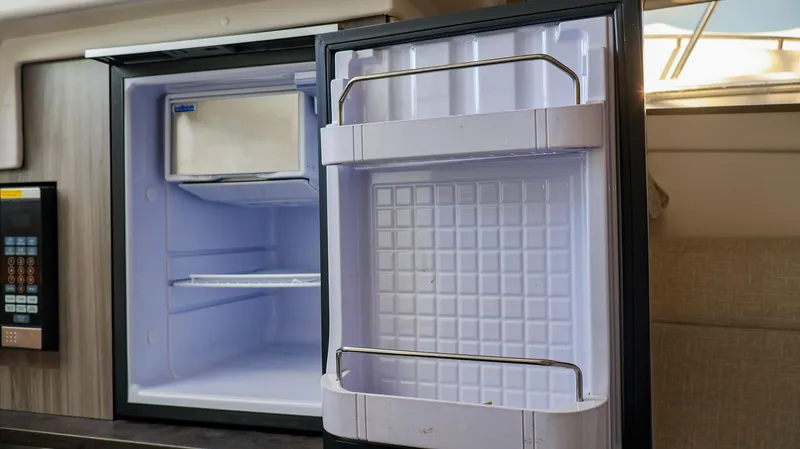 4743jg Yacht Photos Pics Open refrigerator inside 2021 Sea Ray 320 Sundancer yacht cabin.