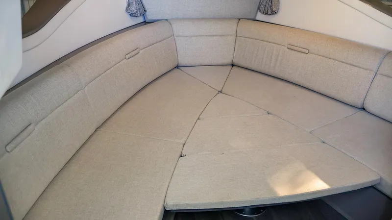 4743jg Yacht Photos Pics 2021 Sea Ray 320 Sundancer interior seating area with beige upholstery.