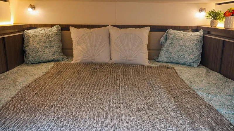 4743jg Yacht Photos Pics Cozy cabin interior of 2021 Sea Ray 320 Sundancer with plush bedding and ambient lighting.