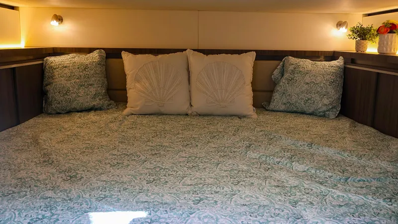 4743jg Yacht Photos Pics Cozy cabin interior of 2021 Sea Ray 320 Sundancer with decorative pillows and soft lighting.