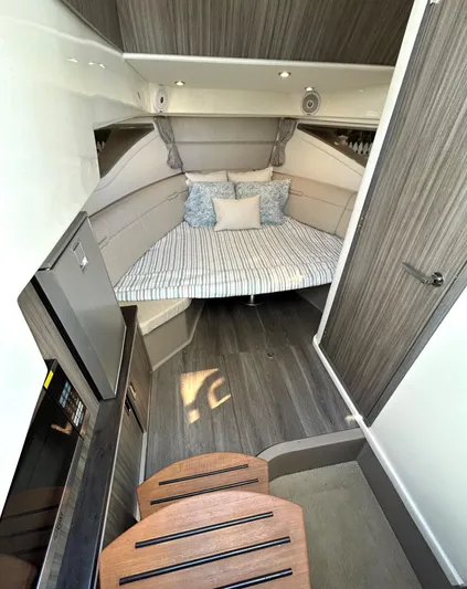 4743jg Yacht Photos Pics Interior cabin of 2021 Sea Ray 320 Sundancer with bed and kitchenette.