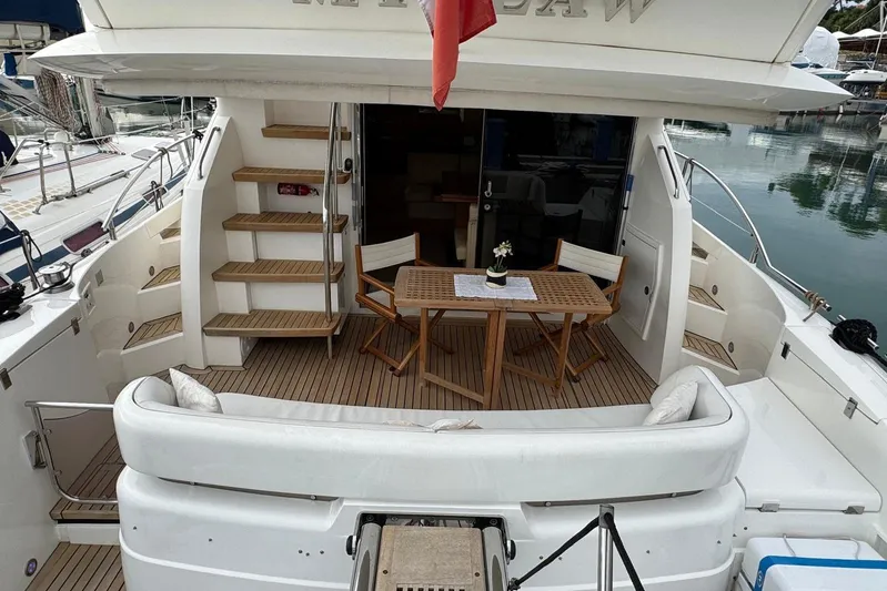 My Law Yacht Photos Pics Luxury 2007 Fairline Phantom 48 yacht with elegant outdoor seating and wooden deck.