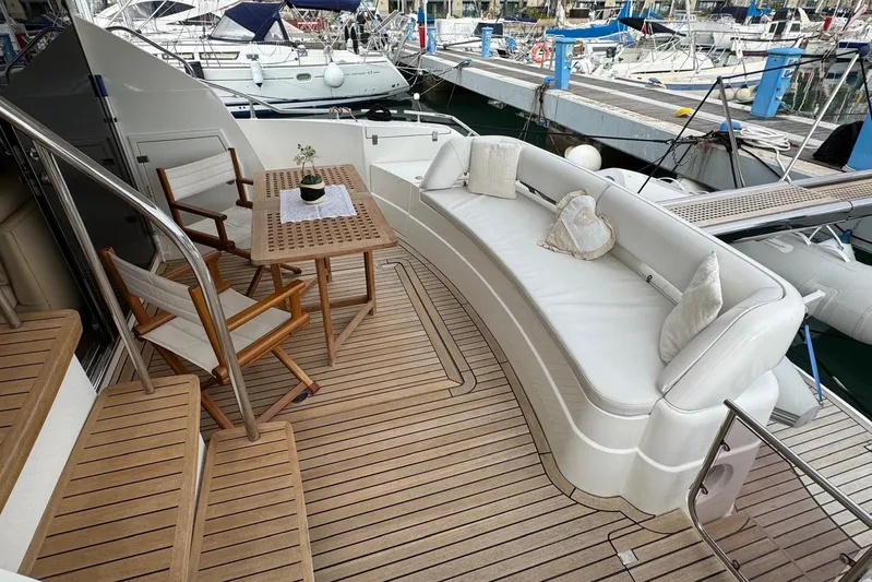 My Law Yacht Photos Pics Luxurious 2007 Fairline Phantom 48 yacht deck with seating and table at marina.
