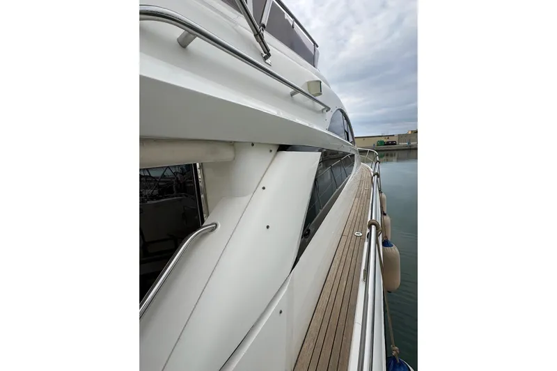 My Law Yacht Photos Pics 2007 Fairline Phantom 48 yacht, side view with wooden deck and railing.