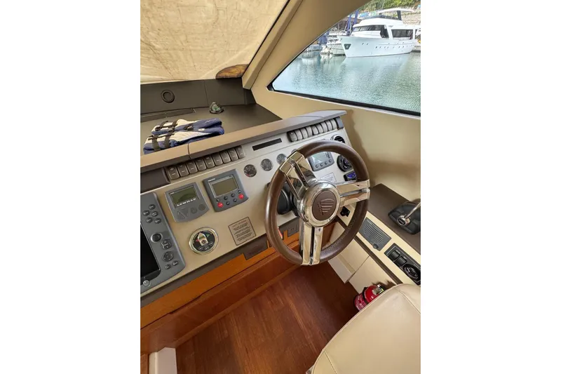 My Law Yacht Photos Pics 2007 Fairline Phantom 48 yacht helm with steering wheel and control panel.