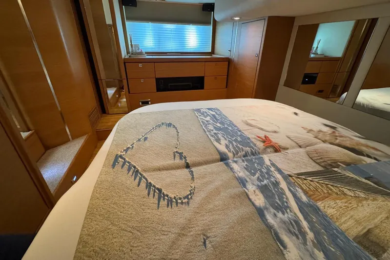 My Law Yacht Photos Pics Luxurious bedroom interior of 2007 Fairline Phantom 48 yacht with beach-themed bedding.