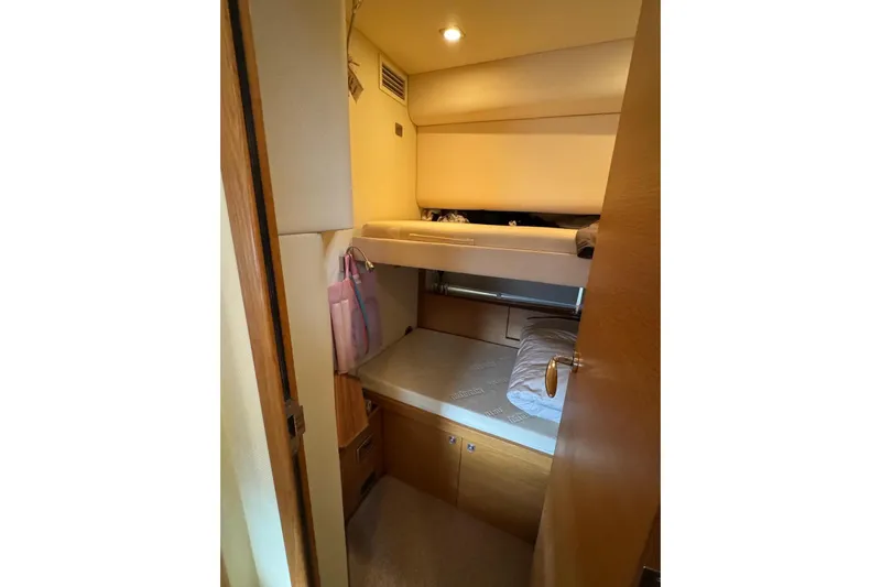 My Law Yacht Photos Pics 2007 Fairline Phantom 48 cabin with bunk beds and wooden interior.