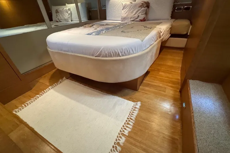 My Law Yacht Photos Pics Luxurious bedroom interior of 2007 Fairline Phantom 48 yacht with wooden flooring and elegant bedding.