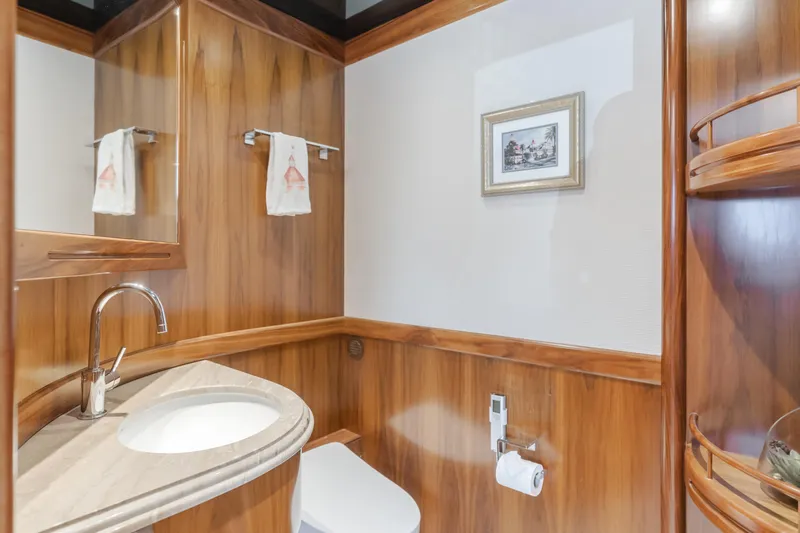 White Lotus Yacht Photos Pics Luxurious bathroom in 2011 President Sterling Tri-Deck yacht with wood paneling and modern fixtures.
